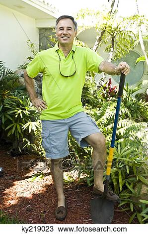 Portrait of a man holding a shovel View Large Photo Image Stock Image - Portrait of a man holding a shovel. Fotosearch