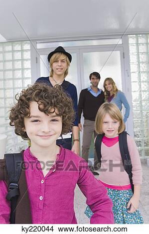Children with a nanny leaving for school View Large Photo Image Picture - Children with a nanny leaving for school. Fotosearch