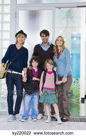 Couple standing with their children and a nanny at the door of a house View Large Photo Image Stock Image - Couple standing with their children and a nanny at the door of a house. Fotosearch