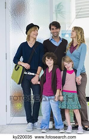 Couple with their children and a nanny at the door of a house View Large Photo Image Stock Photography - Couple with their children and a nanny at the door of a house. Fotosearch