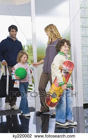 Man entering the house with his children View Large Photo Image Stock Image - Man entering the house with his children. Fotosearch