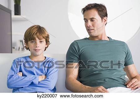 Stock Photo - Man sitting with his son. Fotosearch