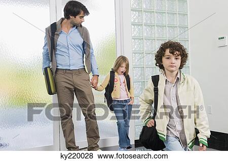 Man with his children entering a house View Large Photo Image Stock Photo - Man with his children entering a house. Fotosearch