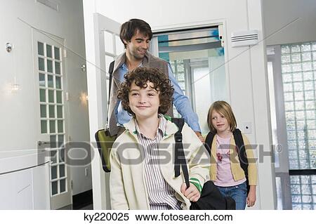 Man with his children entering a house View Large Photo Image Stock Photography - Man with his children entering a house. Fotosearch