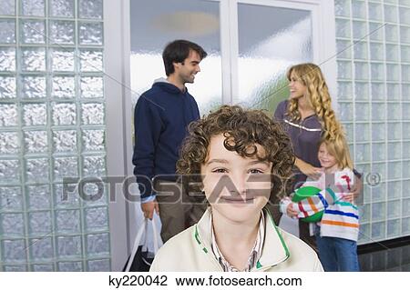 Portrait of a boy with his parents in the background View Large Photo Image Stock Image - Portrait of a boy with his parents in the background. Fotosearch