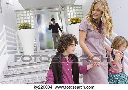 Woman with her children leaving for school View Large Photo Image Picture - Woman with her children leaving for school. Fotosearch