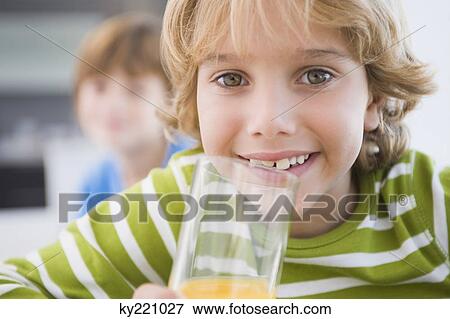 Boy drinking a glass of juice View Large Photo Image Stock Photo - Boy drinking a glass of juice. Fotosearch
