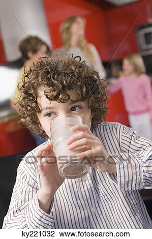Close-up of a boy drinking a glass of milk View Large Photo Image Stock Image - Close-up of a boy drinking a glass of milk. Fotosearch