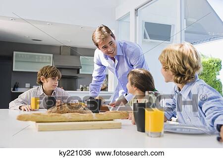 Stock Photograph - Family at the breakfast table. Fotosearch