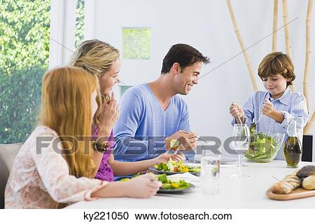 Family at the dining table View Large Photo Image Stock Image - Family at the dining table. Fotosearch
