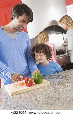 Family cooking food in the kitchen View Large Photo Image Picture - Family cooking food in the kitchen. Fotosearch