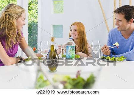 Family having lunch and smiling View Large Photo Image Stock Photo - Family having lunch and smiling. Fotosearch
