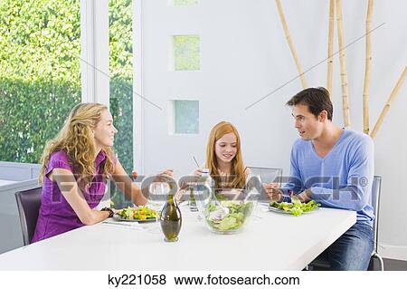 Family having lunch and smiling View Large Photo Image Stock Photo - Family having lunch and smiling. Fotosearch