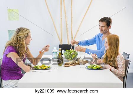 Family having lunch View Large Photo Image Stock Photo - Family having lunch. Fotosearch