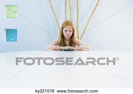 Girl at the dining table View Large Photo Image Stock Photograph - Girl at the dining table. Fotosearch
