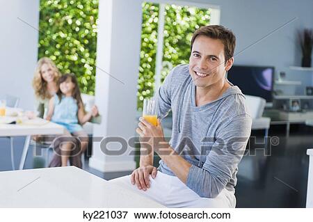 Stock Photo - Man holding a glass of juice. Fotosearch