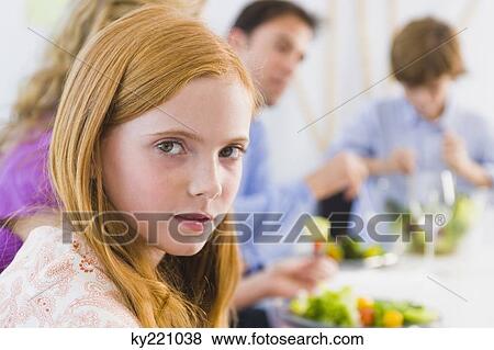 Portrait of a girl at a dining table View Large Photo Image Stock Photo - Portrait of a girl at a dining table. Fotosearch