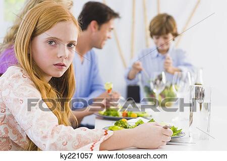 Portrait of a girl at a dining table View Large Photo Image Stock Photo - Portrait of a girl at a dining table. Fotosearch