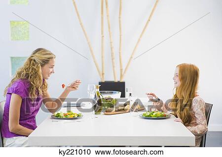 Woman having lunch with her daughter View Large Photo Image Stock Image - Woman having lunch with her daughter. Fotosearch