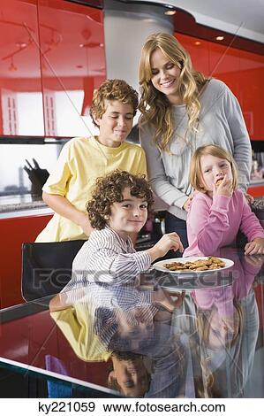 Woman with her children in the kitchen View Large Photo Image Stock Photo - Woman with her children in the kitchen. Fotosearch