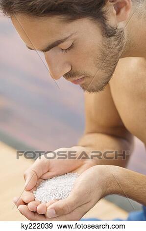 Man holding himalayan salt View Large Photo Image Stock Photo - Man holding himalayan salt. Fotosearch