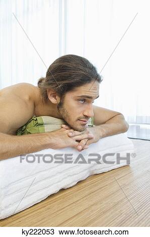 Man lying on a massage table View Large Photo Image Stock Image - Man lying on a massage table. Fotosearch