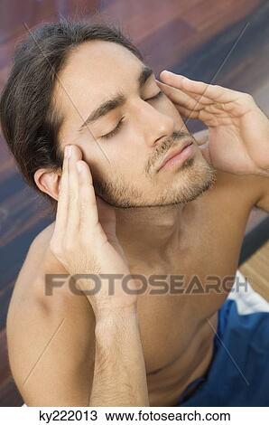 Man massaging his temple View Large Photo Image Stock Image - Man massaging his temple. Fotosearch