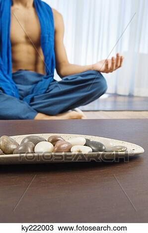 Stock Image - Man practicing yoga. Fotosearch