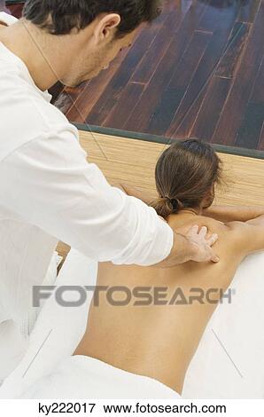 Stock Photo - Man receiving a back massage from a massage therapist. Fotosearch