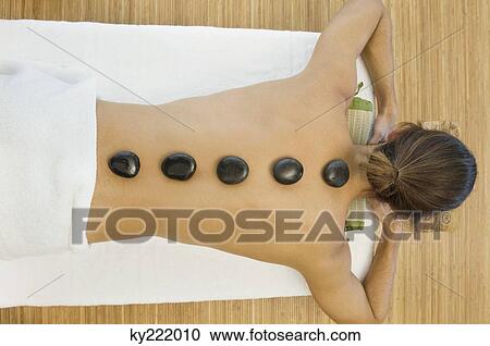 Man receiving hot stone therapy View Large Photo Image Stock Image - Man receiving hot stone therapy. Fotosearch