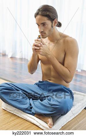 Man smelling aromatherapy oil from a bottle View Large Photo Image Stock Image - Man smelling aromatherapy oil from a bottle. Fotosearch