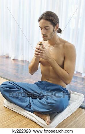 Man smelling aromatherapy oil from a bottle View Large Photo Image Stock Photo - Man smelling aromatherapy oil from a bottle. Fotosearch