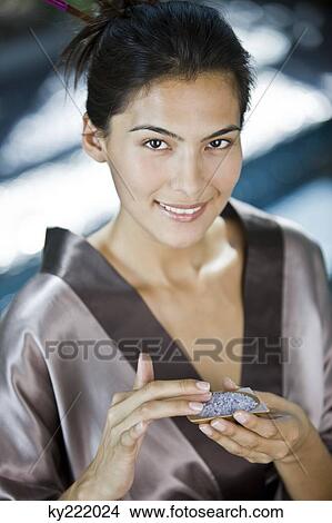 Woman holding a container of bath salt View Large Photo Image Picture - Woman holding a container of bath salt. Fotosearch