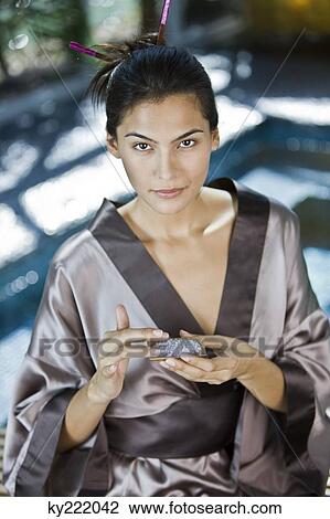 Woman holding a container of bath salt View Large Photo Image Stock Image - Woman holding a container of bath salt. Fotosearch