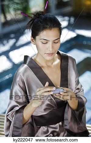 Woman holding a container of bath salt View Large Photo Image Stock Photo - Woman holding a container of bath salt. Fotosearch