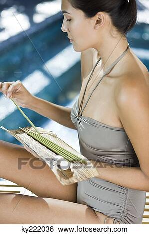 Woman holding incenses and a flower on a leaf View Large Photo Image Stock Photograph - Woman holding incenses and a flower on a leaf. Fotosearch