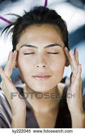 Woman rubbing her temples View Large Photo Image Stock Photography - Woman rubbing her temples. Fotosearch