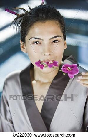 Woman smelling flowers View Large Photo Image Stock Image - Woman smelling flowers. Fotosearch