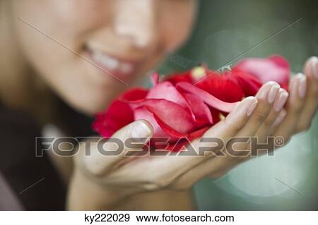 Woman smelling rose flowers View Large Photo Image Stock Photo - Woman smelling rose flowers. Fotosearch