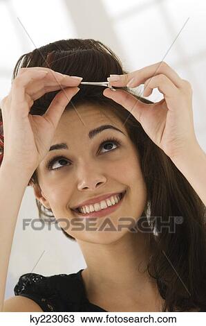 Close-up of a woman removing hair curlers View Large Photo Image Stock Image - Close-up of a woman removing hair curlers. Fotosearch