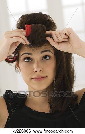 Close-up of a woman removing hair curlers View Large Photo Image Stock Photograph - Close-up of a woman removing hair curlers. Fotosearch