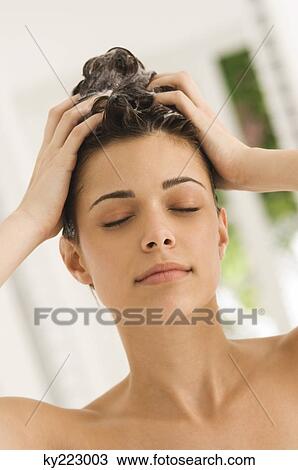 Close-up of a woman shampooing her hair View Large Photo Image Stock Image - Close-up of a woman shampooing her hair. Fotosearch