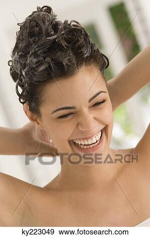 Close-up of a woman shampooing her hair View Large Photo Image Stock Photo - Close-up of a woman shampooing her hair. Fotosearch