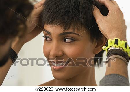 Stock Photograph - Person's hands in a woman's hair. Fotosearch