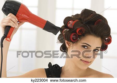 Portrait of a woman drying her hair View Large Photo Image Picture - Portrait of a woman drying her hair. Fotosearch