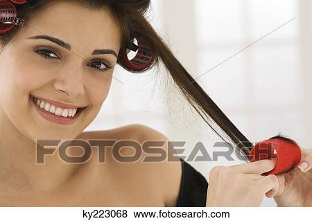 Portrait of a woman removing hair curlers View Large Photo Image Stock Photo - Portrait of a woman removing hair curlers. Fotosearch