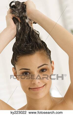 Portrait of a woman shampooing her hair View Large Photo Image Stock Image - Portrait of a woman shampooing her hair. Fotosearch