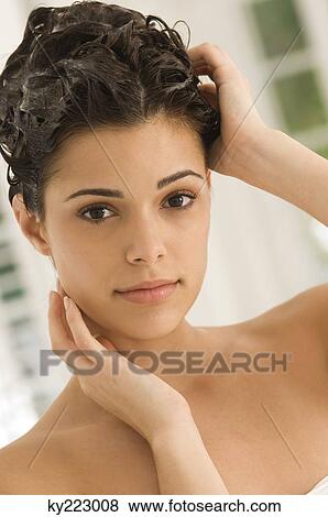 Portrait of a woman shampooing her hair View Large Photo Image Stock Photo - Portrait of a woman shampooing her hair. Fotosearch