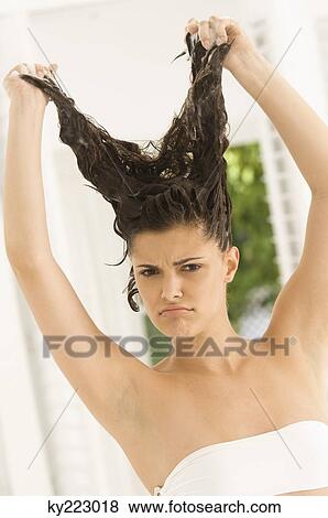Portrait of a woman shampooing her hair View Large Photo Image Stock Photo - Portrait of a woman shampooing her hair. Fotosearch