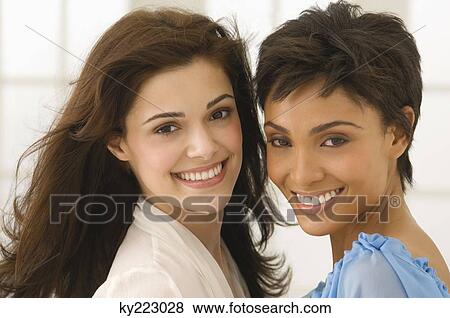 Portrait of two female friends smiling View Large Photo Image Stock Photo - Portrait of two female friends smiling. Fotosearch